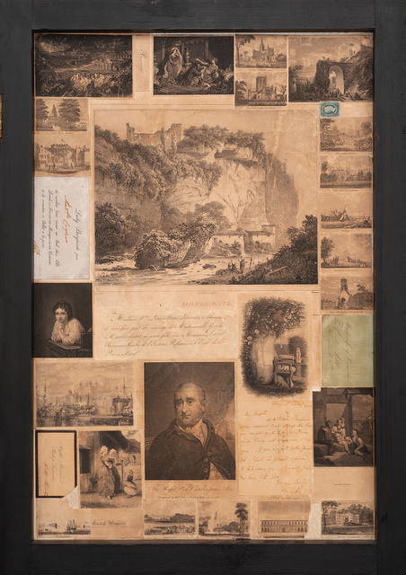 A collage of photographs and handwritten scraps of paper mounted in a black frame