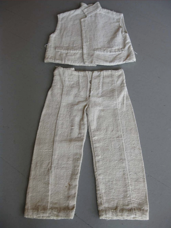 A small, light-colored set of a sleeveless jacket and pants